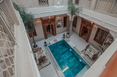 an overhead view of a swimming pool in a building at Riad Aslal in Marrakech