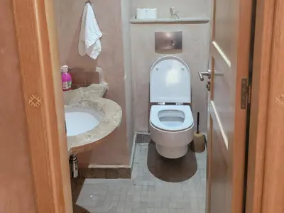 a small bathroom with a toilet and a sink at les jardins d'atlas waky palm golf in Marrakech