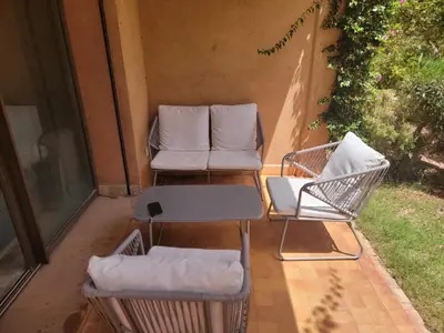two chairs and a table on a patio at les jardins d'atlas waky palm golf in Marrakech