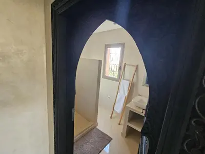 a bathroom with a mirror and a sink in a room at Villa Dar AL Manel in Aït Amara