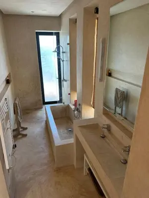 a bathroom with a sink and a large mirror at Villa Kela Serene in Marrakech
