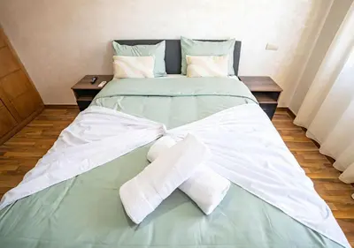 a bed with white sheets and towels on it at Appart Mayar 52 in Marrakech