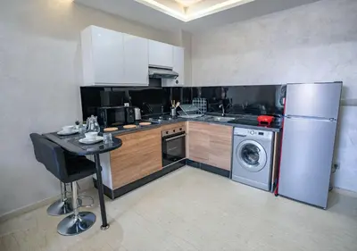 a kitchen with a refrigerator and a washing machine at Appart Mayar 52 in Marrakech