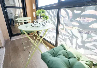 a table in a room next to a large window at Appart Mayar 52 in Marrakech