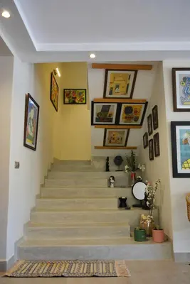 a staircase in a house with pictures on the walls at Villa Tulum - Indoor Spa & Pools in Marrakech