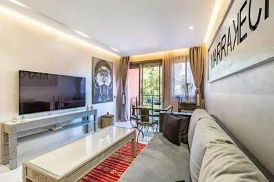 a living room with a couch and a tv at New ! Bright And Comfortable App in city center in Marrakech