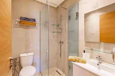 a bathroom with a shower and a toilet and a sink at Résidence Golfique ,Piscine,Jardin terrasse privée in Marrakech
