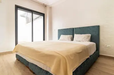 a bedroom with a large bed with a large window at Appartement Miramas 2 Gueliz pool,Gym in Marrakech