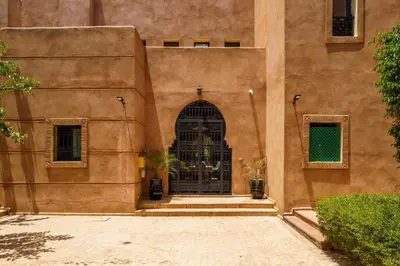 an entrance to a building with a black gate at Villa Riad Sultana in Marrakech