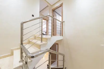 a metal spiral staircase in a house at Cozy appartement à Gueliz juste les familles in Marrakech