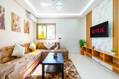 a living room with a couch and a tv at Cozy appartement à Gueliz juste les familles in Marrakech