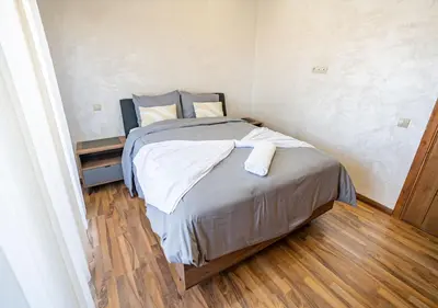 a small bedroom with a bed with a wooden floor at Appart Mayar 58 in Marrakech