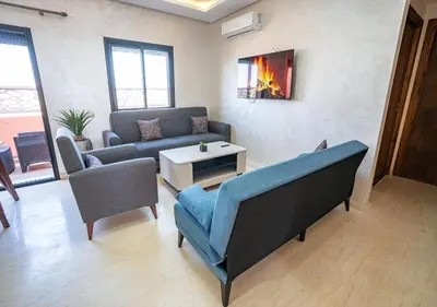 a living room with a couch and a table at Appart Mayar 58 in Marrakech