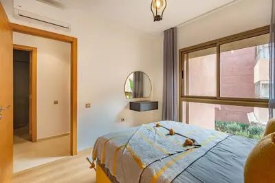 a bedroom with a bed and a window at New! Résidence de Luxe avec Piscine & parking in Marrakech