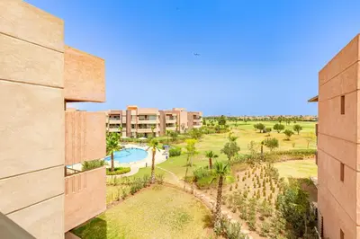 an aerial view of a resort with a pool and palm trees at New! App Spacieux avec Piscine et Parking à Saphir in Marrakech