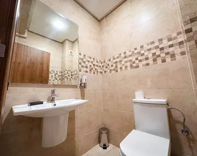 a bathroom with a sink and a toilet and a mirror at Bel appartement haut standing in Marrakech