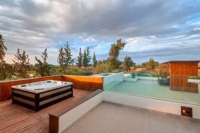 a balcony with a hot tub on a deck at Villa des stars in Marrakech