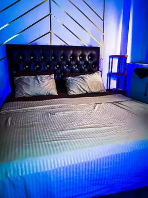 a bedroom with a large bed in a blue room at Your Home Away From Home in Marrakech