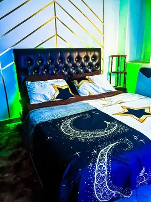 a bedroom with a bed with a bedspread with at Your Home Away From Home in Marrakech