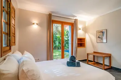 a bedroom with a white bed and a window at Villa Dar Chama ,piscine privée , Au cœur de Marrakech in Marrakech