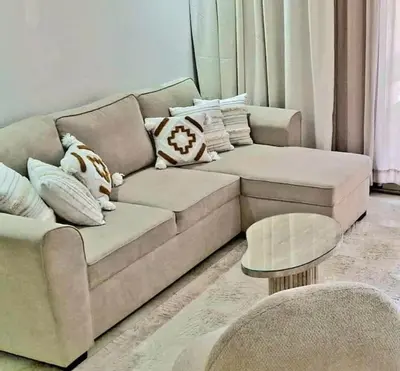 a living room with a couch and a table at Hypercentre, Cosy, 2 piscines, Sauna, Hammam in Marrakech