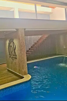 a swimming pool in a building with a swimming pool at Hypercentre, Cosy, 2 piscines, Sauna, Hammam in Marrakech