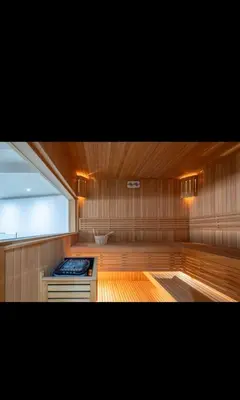 a sauna with a window and a stove in it at Hypercentre, Cosy, 2 piscines, Sauna, Hammam in Marrakech