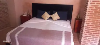 a bedroom with a large bed with two pillows at Riad maison Bounouar in Marrakech
