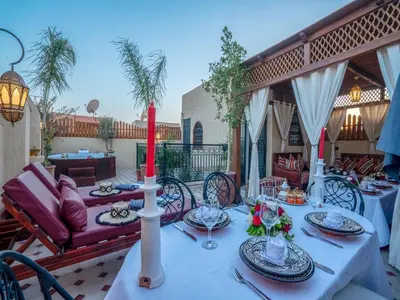 a table with a candle on a patio at Riad Le Nid De Fatima in Marrakech
