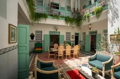 a patio with a table and chairs in a building at Charming Medina Riad 8 rooms with pool - Riad INN Medina in Marrakech