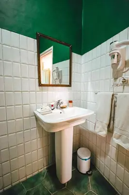 a bathroom with a sink and a mirror at Charming Medina Riad 8 rooms with pool - Riad INN Medina in Marrakech