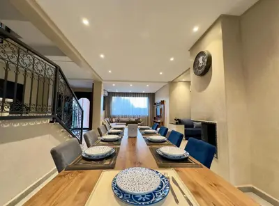 a large dining room with a long table and chairs at Villa Atlas view in Marrakech