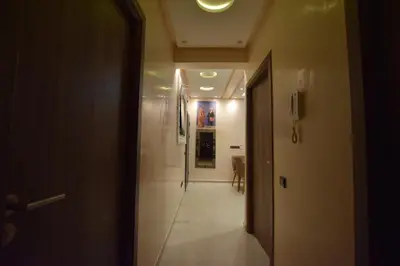 a hallway with a hallway leading to a room with a hallway at Appartement familial proche aéroport et Oasiria in Marrakech
