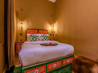 a bedroom with a large bed in a room at Riad Irhalne in Marrakech