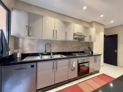 a kitchen with white cabinets and a sink at Villa Oasis in Marrakech