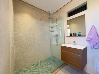 a bathroom with a glass shower and a sink at Villa Oasis in Marrakech
