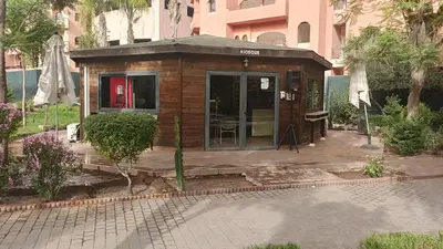 a small wooden house with a patio in a courtyard at premium village M355 in Marrakech