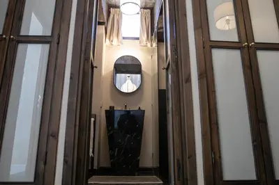 a hallway of a building with a man in a mirror at Riad Lulua Exclusif 3 Chambres et Piscine Rooftop in Marrakech