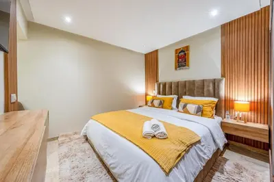 a bedroom with a large bed with a yellow blanket at Appartement de prestige Gueliz kasbel 212 in Marrakech