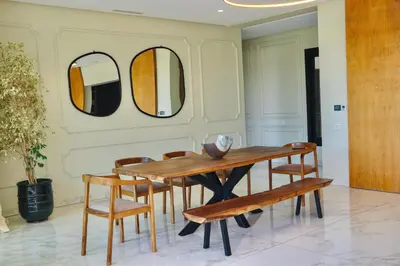 a dining room with a table and chairs and mirrors at Villa SELINA Luxury -5 suites , Piscine privée chauffée, sans vis à vis, calme & sureté - Padle , Family only in Marrakech
