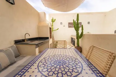 a kitchen with a table with a sink and a cactus at Riad Les Suites Marrakech in Marrakech