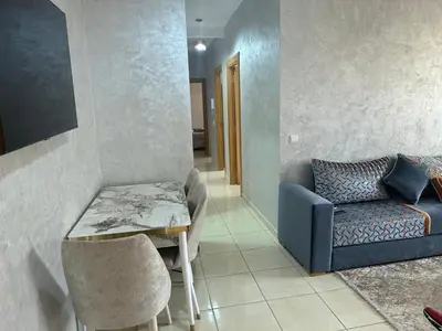 a living room with a table and a couch at Liton's Avenue in Marrakech
