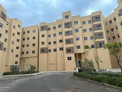 an empty parking lot in front of a large building at Liton's Avenue in Marrakech