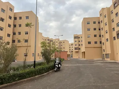 a motorcycle parked in a parking lot in front of buildings at Liton's Avenue in Marrakech