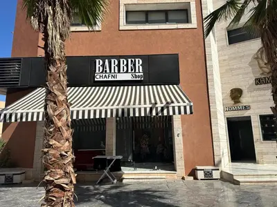 a barber shop with a sign on the side of a building at Liton's Avenue in Marrakech