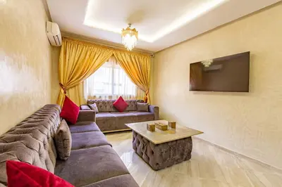a living room with a couch and a table at New! App Émeraude Confort avec piscine & parking in Marrakech