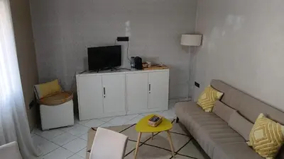 a living room with a couch and a tv at APPARTENT 11 à GUELIZE HIVERNAGE in Marrakech