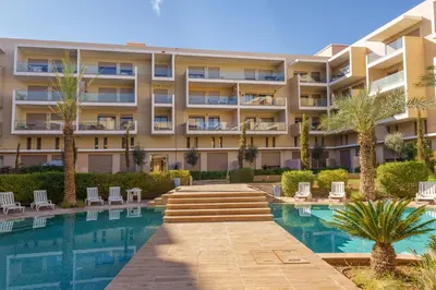 an apartment building with a swimming pool at Red appart in Marrakech