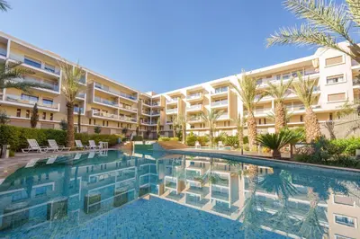 an image of a hotel with a swimming pool at Red appart in Marrakech
