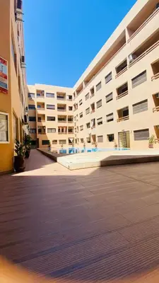 an empty parking lot next to a large building at Résidence nour 5 in Marrakech